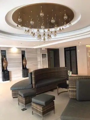 a living room with couches and a chandelier at Condominium Fame Residence in Manila