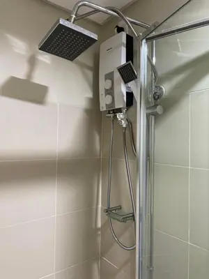 a shower with a shower head in a bathroom at Condominium Fame Residence in Manila