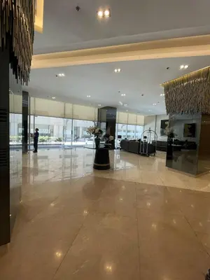 a lobby with a person standing in a building at Condominium Fame Residence in Manila