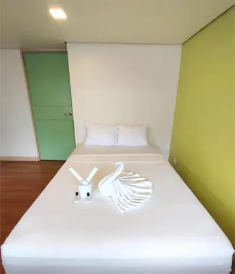 a bed with two white items on it in a room at Sulit Condo Unit Santa Mesa Manila in Manila