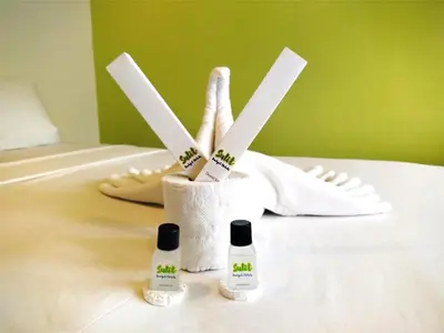 a toothbrush holder with toothbrushes and two bottles ofodorizers at Sulit Condo Unit Santa Mesa Manila in Manila