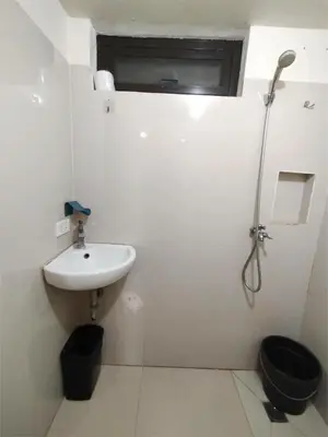 a white bathroom with a sink and a toilet at Sulit Condo Unit Santa Mesa Manila in Manila