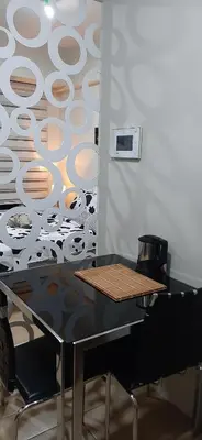 a black table and chairs with a wall at Cozy City View Condo @ Newport NAIA T3 Airport & RWM in Manila