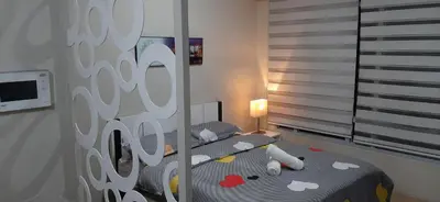 a bedroom with a bed with a mirror at Cozy City View Condo @ Newport NAIA T3 Airport & RWM in Manila