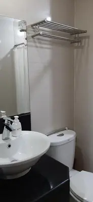 a bathroom with a white toilet and a sink at Cozy City View Condo @ Newport NAIA T3 Airport & RWM in Manila