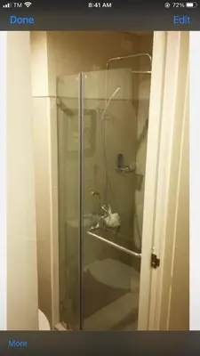a glass shower in a bathroom with a toilet at Shell Residence MOA Manila by JO Alano in Manila