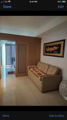 a bedroom with a bed and a door in a room at Shell Residence MOA Manila by JO Alano in Manila