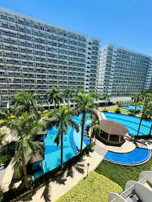 an aerial view of a resort with a swimming pool at Shell Residence MOA Manila by JO Alano in Manila