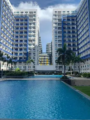 a large swimming pool in front of tall buildings at Sea Residences by EXIN in Manila