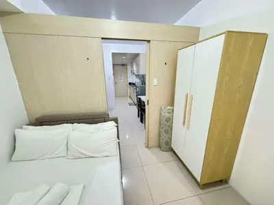 a small room with a bed and a kitchen at Sea Residences by EXIN in Manila
