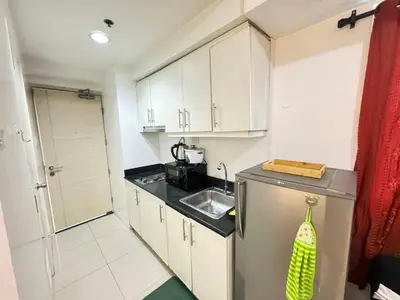 a small kitchen with a sink and a refrigerator at Sea Residences by EXIN in Manila
