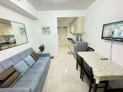 a living room with a couch and a table at Sea Residences by EXIN in Manila
