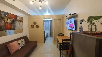 a living room with a couch and a table at Sea Residences EZBedz in Manila