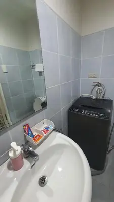 a bathroom with a sink and a mirror at Sea Residences EZBedz in Manila