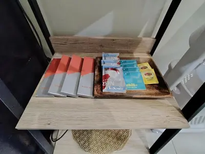 a wooden table with books on top of it at SMDC Coast Residences - Entire 1BR Condo with stunning view from 24th Floor in Manila