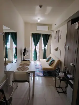 a living room with a couch and a table in it at SMDC Coast Residences - Entire 1BR Condo with stunning view from 24th Floor in Manila