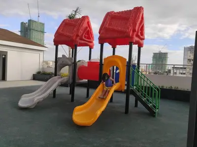 a child on a slide on a playground at SMDC Coast Residences - Entire 1BR Condo with stunning view from 24th Floor in Manila
