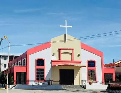 a red and white church with a cross on top at 2-Bedroom Condo in Imus Cavite with UNLI WIFI, 50