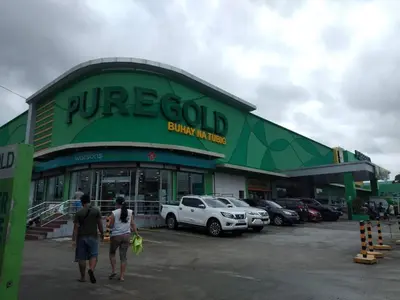 two people walking in front of a car dealership at 2-Bedroom Condo in Imus Cavite with UNLI WIFI, 50
