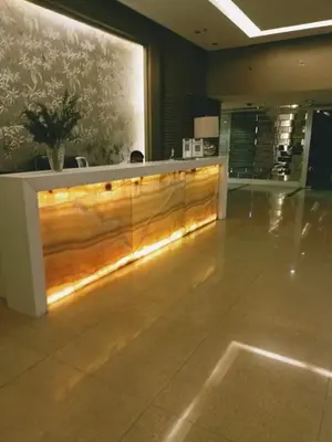 a lobby with a wooden reception desk in a building at 16E 1 BR Mosaic staycation in Manila
