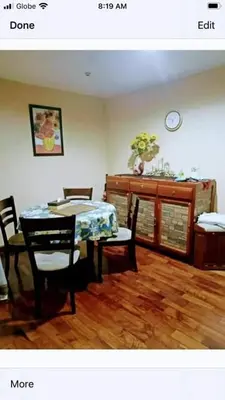 a living room with a table and chairs and a dining room at 16E 1 BR Mosaic staycation in Manila