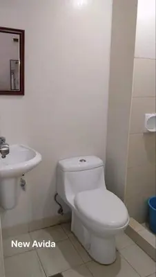 a bathroom with a white toilet and a sink at New Avida JVB Homestyle in Manila