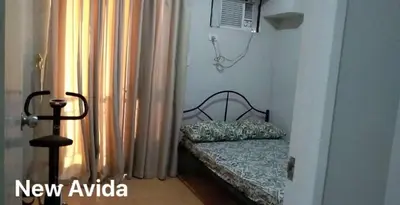 a bedroom with a bed and a window with curtains at New Avida JVB Homestyle in Manila