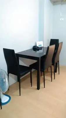 a black table with chairs and a phone on it at New Avida JVB Homestyle in Manila