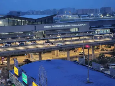 an overhead view of a busy city intersection with traffic at High-Rise Apartment Condo near NAIA Terminal 3 with a Perfect Airport Front-View in Manila