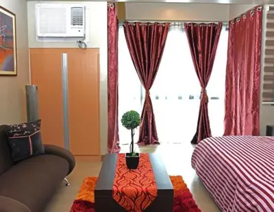 a room with a bed and a couch and a table at High-Rise Apartment Condo near NAIA Terminal 3 with a Perfect Airport Front-View in Manila