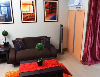 a living room with a couch and a table at High-Rise Apartment Condo near NAIA Terminal 3 with a Perfect Airport Front-View in Manila