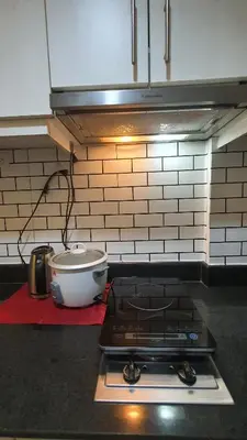 a kitchen with a stove and a bowl on a counter at EZPlace Sea Residences in Manila