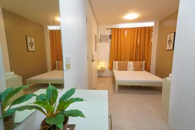 a hospital room with two beds and a potted plant at TARASA HOSTEL in Manila