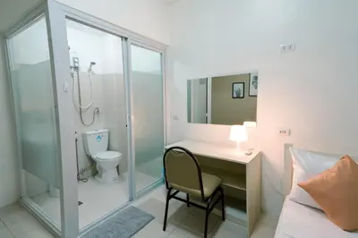 a bathroom with a shower and a desk and a toilet at TARASA HOSTEL in Manila