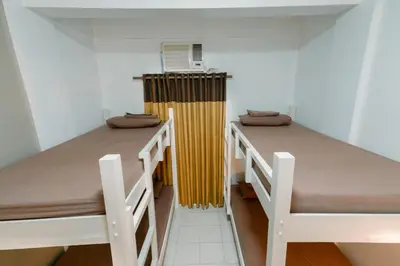 two beds in a dorm room with a heater at TARASA HOSTEL in Manila