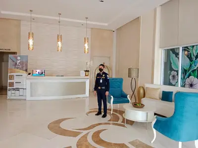 a man in uniform standing in a living room at 150 Newport Boulevard Near NAIA Terminal 3 in Manila