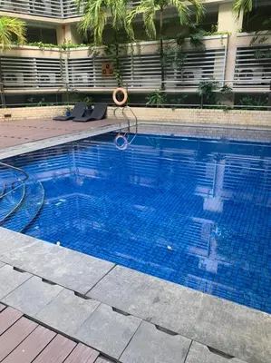 a large blue swimming pool with a hose in it at 150 Newport Boulevard Near NAIA Terminal 3 in Manila