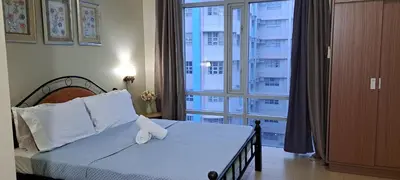 a bedroom with a bed and a large window at Affordable Suite at 150 Newport Blvd near NAIA T3 in Manila