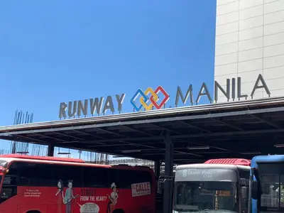 a bus station with buses parked under a railway manila sign at Affordable Suite at 150 Newport Blvd near NAIA T3 in Manila