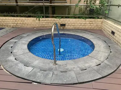 a swimming pool with a fountain in the middle at Affordable Suite at 150 Newport Blvd near NAIA T3 in Manila