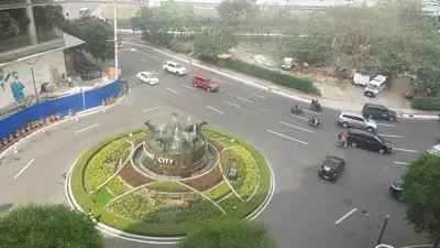 an aerial view of a city street with cars and a fountain at Affordable Suite at 150 Newport Blvd near NAIA T3 in Manila