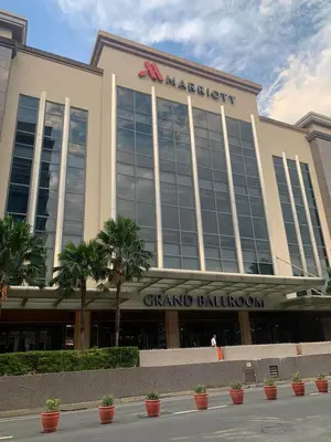 a large building with a sign on top of it at Affordable Suite at 150 Newport Blvd near NAIA T3 in Manila