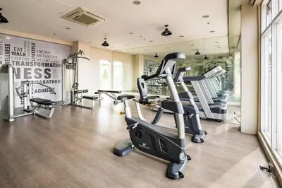 a gym with several tread machines in a room at R'Holistay Vista Heights Legarda near CEU San Beda in Manila