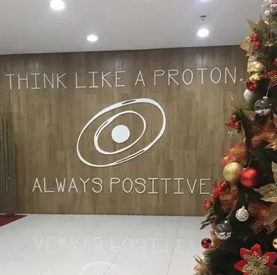 a sign that says think like a proton always positive at R'Holistay Vista Heights Legarda near CEU San Beda in Manila