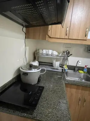 a kitchen with a sink and a pot on a counter at Torre DeManila TaftAvenue KingBed1bedroomBalcony 65InchesTV Rooftop Viewing LunetaPark ManilaOcean ManilaBay US Embassy in Manila