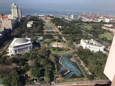an aerial view of a city with a river at Torre DeManila TaftAvenue KingBed1bedroomBalcony 65InchesTV Rooftop Viewing LunetaPark ManilaOcean ManilaBay US Embassy in Manila