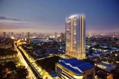 a city skyline with a tall building at night at Torre DeManila TaftAvenue KingBed1bedroomBalcony 65InchesTV Rooftop Viewing LunetaPark ManilaOcean ManilaBay US Embassy in Manila