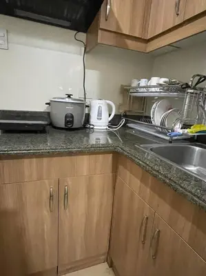 a kitchen counter with a pot and a sink at Torre DeManila TaftAvenue KingBed1bedroomBalcony 65InchesTV Rooftop Viewing LunetaPark ManilaOcean ManilaBay US Embassy in Manila