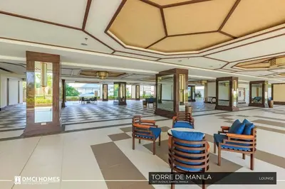 a lobby of a hotel with chairs and tables at Torre DeManila TaftAvenue KingBed1bedroomBalcony 65InchesTV Rooftop Viewing LunetaPark ManilaOcean ManilaBay US Embassy in Manila