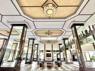 a large building with a ceiling with a clock on it at Torre DeManila TaftAvenue KingBed1bedroomBalcony 65InchesTV Rooftop Viewing LunetaPark ManilaOcean ManilaBay US Embassy in Manila